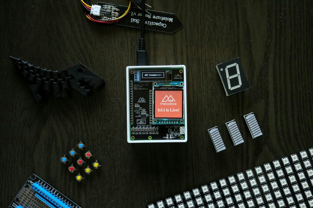 electronic components laid out on a wooden table